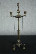 A nineteenth century brass candlestick. With three arms of candle holders bound by chains. With