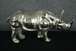 An aluminium cast rhino figure. Lightly polished. H.25 W.50cm.