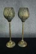 A pair of modern candle holders. Light metal in a painted distressed finish with two glass candle