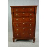 An early 19th century satinwood and crossbanded Biedermeier secretaire chest of six drawers with a