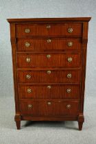 An early 19th century satinwood and crossbanded Biedermeier secretaire chest of six drawers with a
