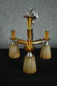 A 1930s Art Deco chandelier. Chromed metal with orange glass surrounds and three branches of