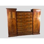 Compactum wardrobe, early 19th century flame mahogany with central bank of six drawers flanked by