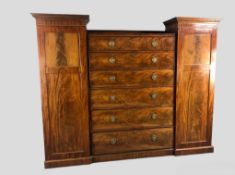 Compactum wardrobe, early 19th century flame mahogany with central bank of six drawers flanked by