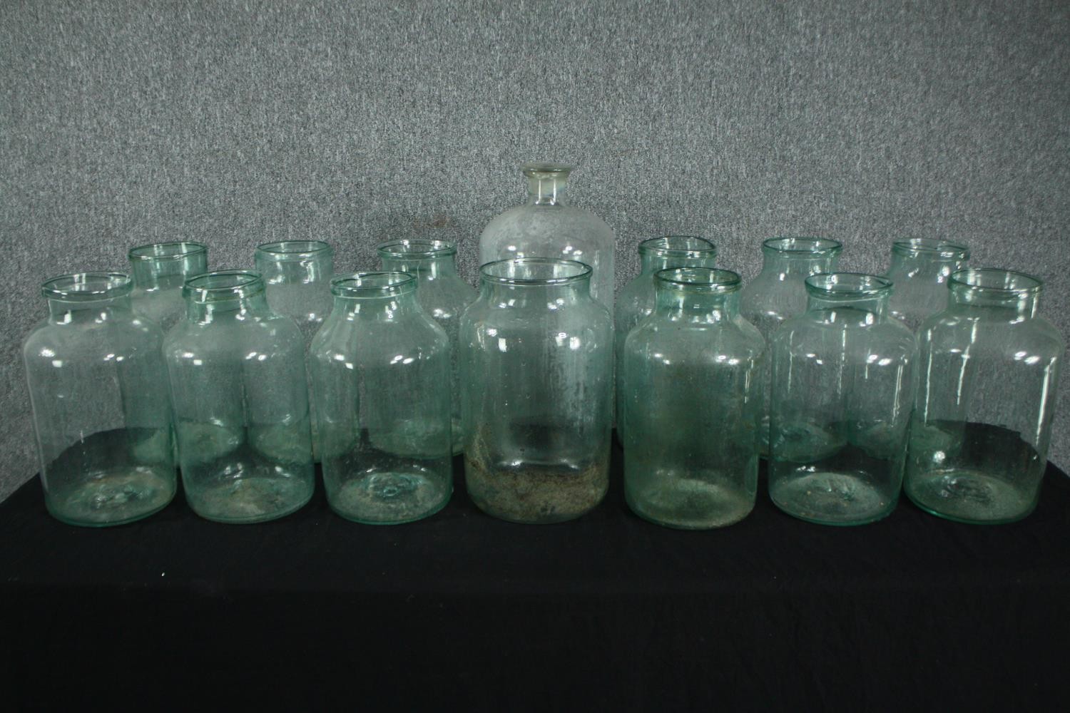 A collection of fourteen large glass pickling jars. Probably early twentieth century but maybe