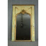 A 19th century French painted panel with giltwood and gesso pier glass with Rococo cresting above