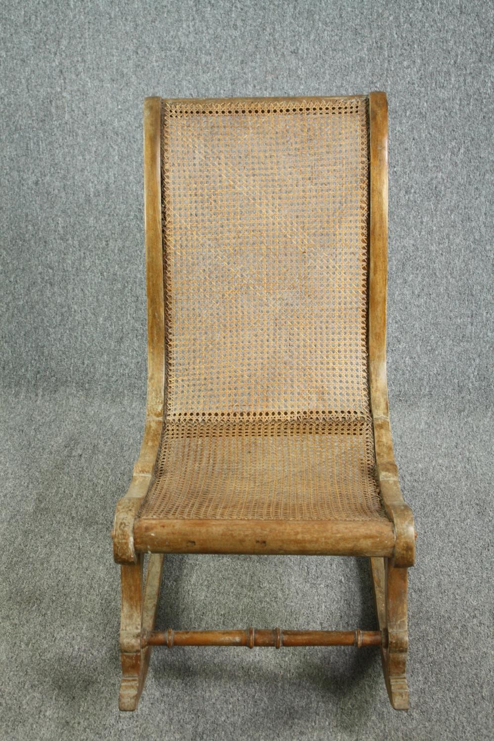 Rocking chair, 19th century beech framed and caned. H.90cm.