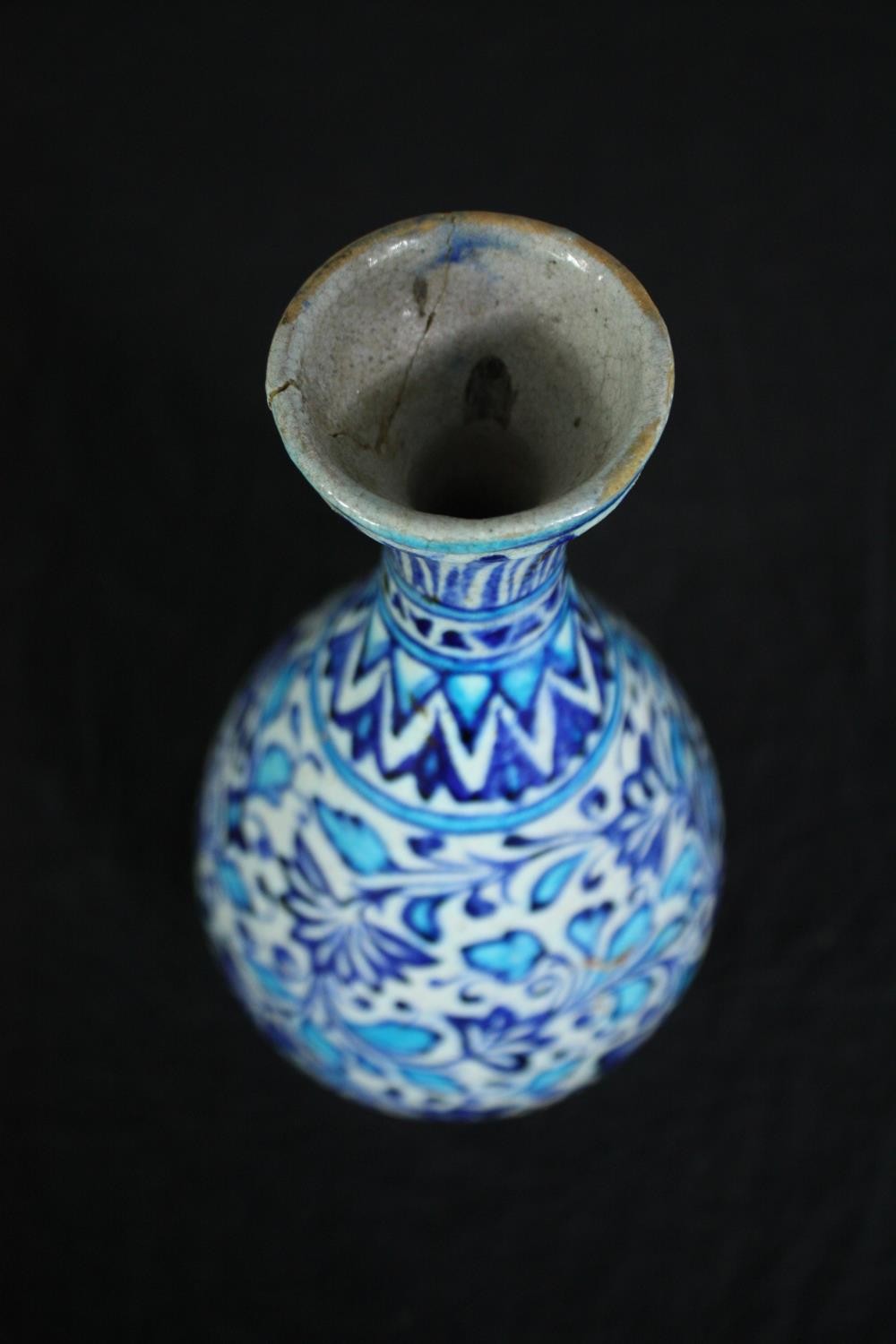 An early 20th century Multani blue and white floral hand painted vase. A little chipped with signs - Image 2 of 5