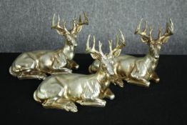 Three gold painted poly-resin reindeer figures. H.20 W.27cm. (each)