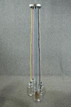 A ceiling light made up of a cluster of jam jars with coloured cable. L.147cm.