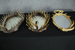 A set of three mirrors decorated with a frame of moulded antlers and backed with velvet. H.50 W.