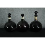 Three large 19th century blown coloured glass apothecary bottles with stoppers (all broken on the