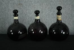 Three large 19th century blown coloured glass apothecary bottles with stoppers (all broken on the