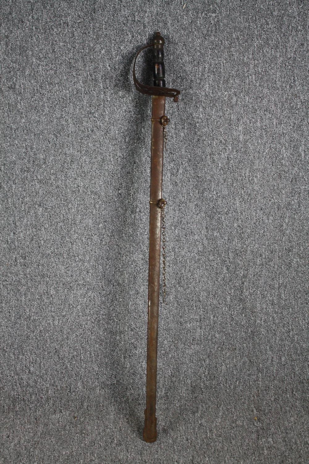 A sword and scabbard. Quite rusted and without a visible maker's mark. With a wooden handle and