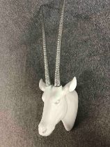 A decorative wall mounted impala head. Porcelain with silver chromed horns. L.110cm.