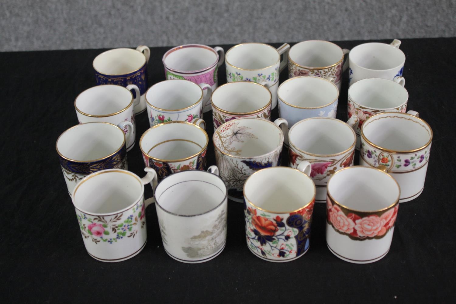 A mixed collection of 19th century hand decorated coffee cans. With gilt edging and mostly floral