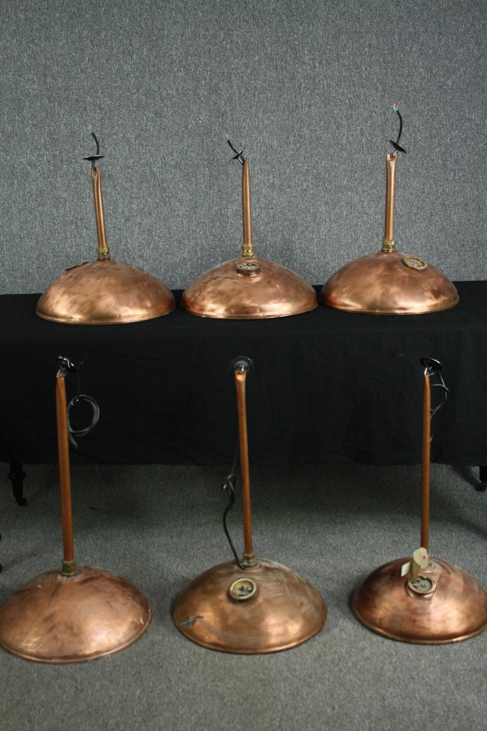 Upcycling. A set of six copper downlights salvaged from the tops of old storage boilers. H.50cm