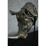 A moulded Rhino head on a wooden display stand. H.40cm.