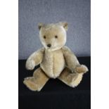 A large vintage Teddy Bear with jointed limbs. Unnamed and without a label. H.69cm.