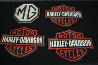A collection of four MG and Harley Davidson signs. Modern metal reproductions. H.26 W.34cm. (