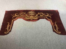 A 19th century red silk velvet pelmet with classical flower urn design, embroidered with gold and