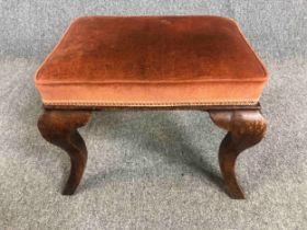 An 18th century walnut stool on cabriole supports. H.40 W.51 D.41cm.