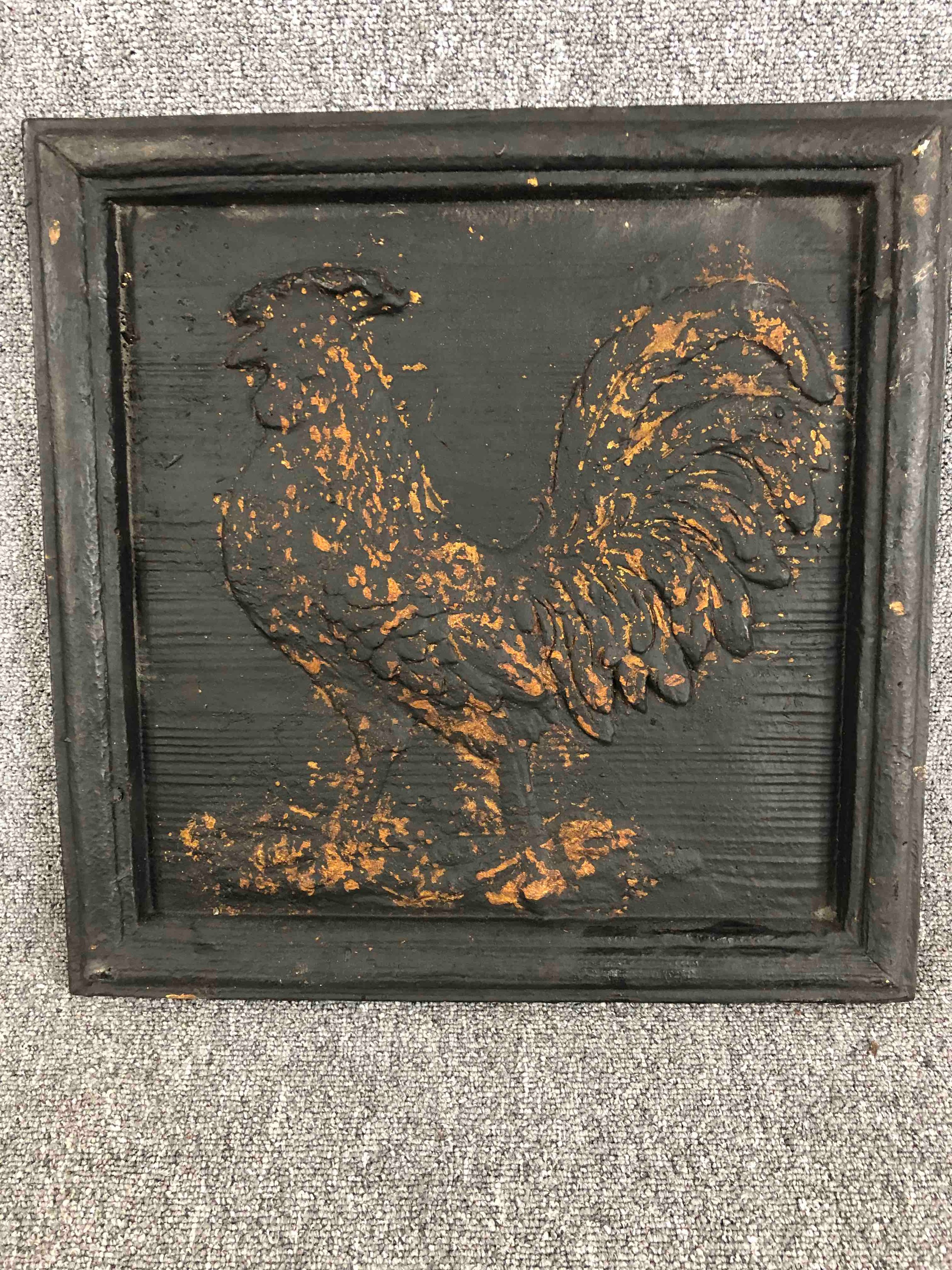 A modern carved panel of a cockerel. Painted black with a worn distressed finish. H.51 W.51cm.