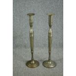 A pair of elongated silver plated brass candlesticks. In the neoclassical style. Circa 1930. H.80cm.