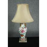 A 19th century hand painted porcelain vase turned table lamp decorated with stylised flowers and