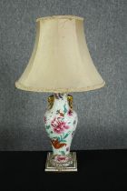 A 19th century hand painted porcelain vase turned table lamp decorated with stylised flowers and