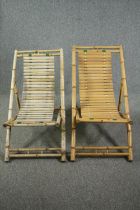 A pair of slatted bamboo deck chairs.