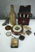 A miscellany of nine items including a cased set of three glass bottles, a German Veranderlich
