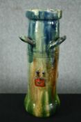 A Flemish Art Deco vase with a stylised watery blue and green glaze decorated with berries. Signed