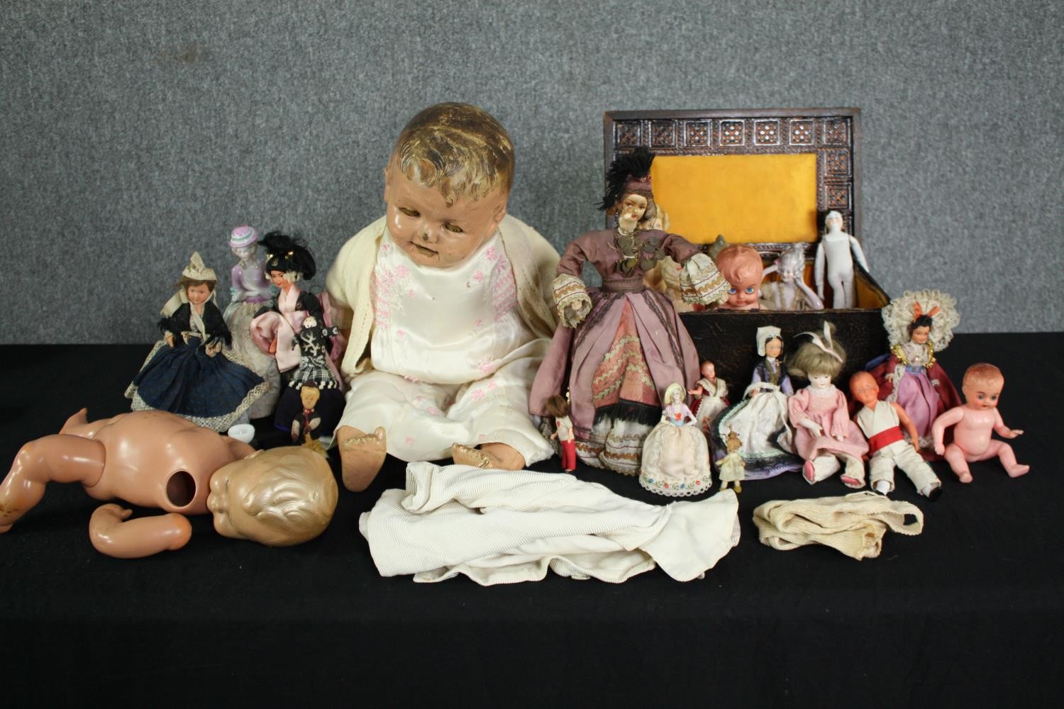 A collection of 19th and early 20th century dolls, including an Indian doll in traditional silk