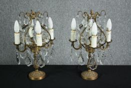 A pair of mid-century candelabra type brass table lamps. Decorated with hanging teardrops and star