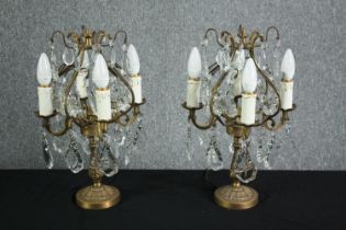 A pair of mid-century candelabra type brass table lamps. Decorated with hanging teardrops and star