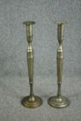 A pair of elongated silver plated brass candlesticks. In the neoclassical style. Circa 1930. H.80cm.