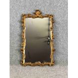 Pier mirror, early 20th century carved giltwood with foliate cresting and scrolling decoration. H.