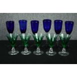 A set of six hand blown cobalt blue wine glasses with clear stems long with a set of five emerald