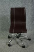 A contemporary office desk chair in faux leather upholstery.