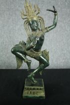 A Khmer style bronze figure of Apsara in a dance pose on a lotus form base. H.42cm.
