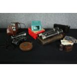 A collection of photographic and cinematic equipment and binoculars. Includes a Minolta Pocket