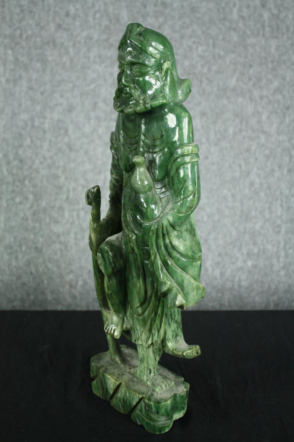 A 20th century carved spinach jade figure of a Chinese elder. H.43cm. - Image 3 of 5