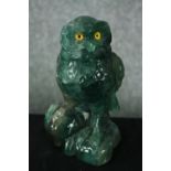 A carved fluorite owl with yellow glass eyes. H.18cm.