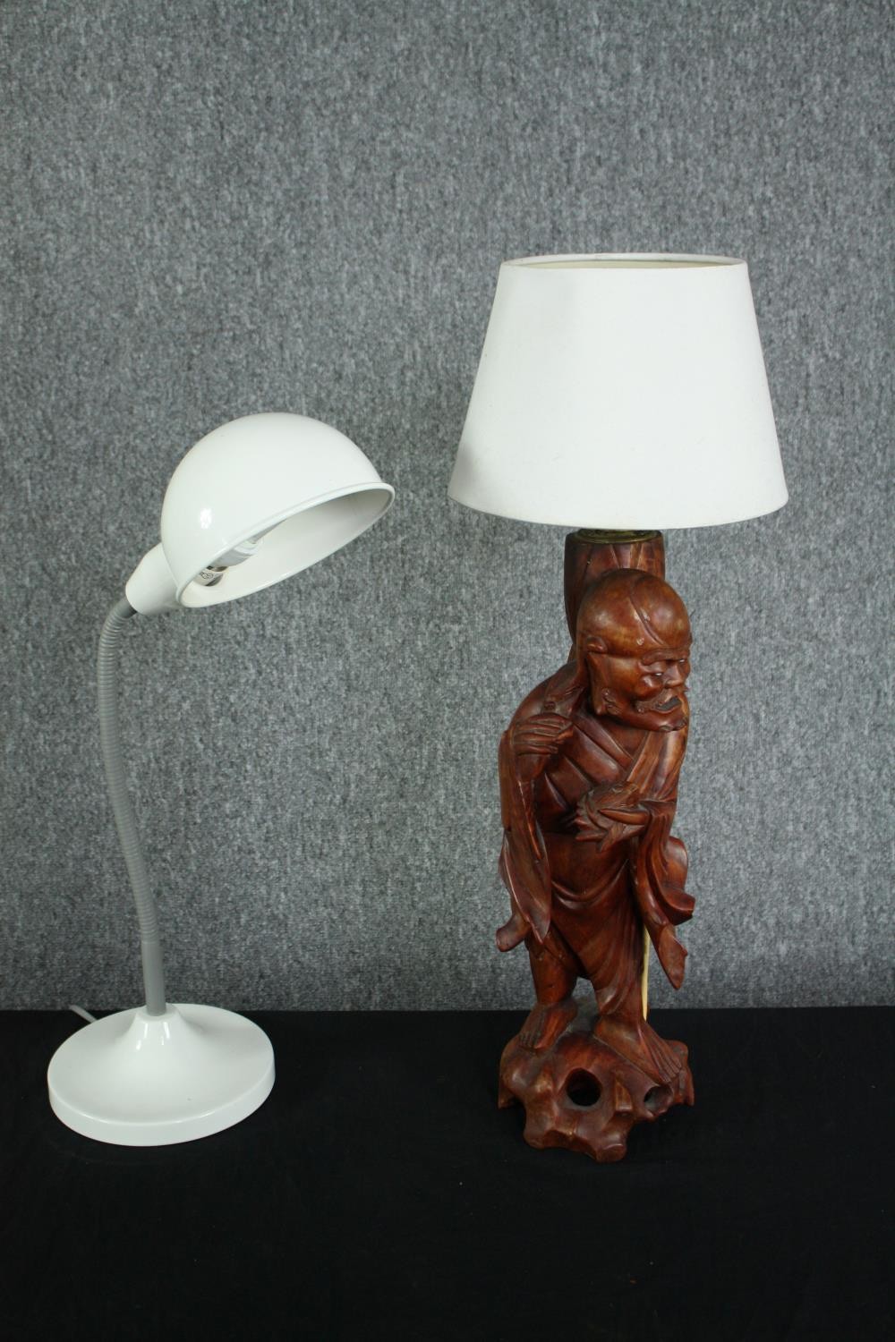 A mid century carved figurative Chinese lamp with brass fittings and a modern desk lamp. H.60cm. (