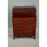 A Georgian mahogany roll top dressing table with rising lid fitted with vanity mirror. (The curved