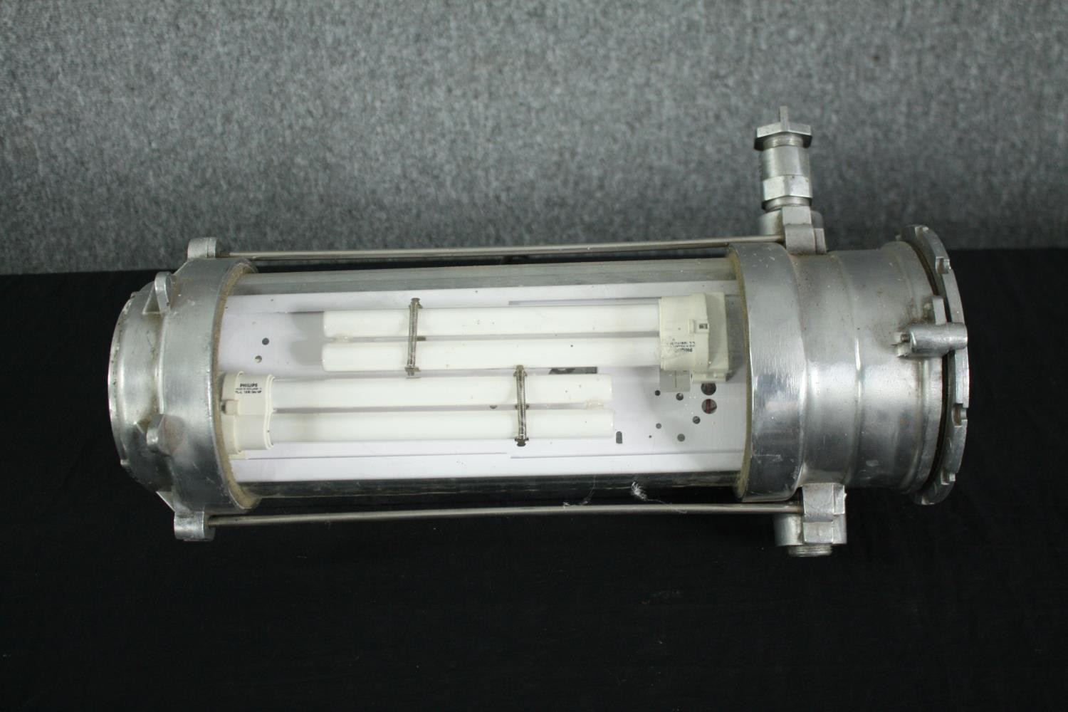 A mid century industrial aluminium and tubular glass wall light with fluorescent bulb. Originating