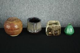 A collection of studio pottery including a round pot with the lid doubling as a bowl. Also, a