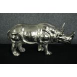 An aluminium cast rhino figure. Lightly polished. H.25 W.50cm.