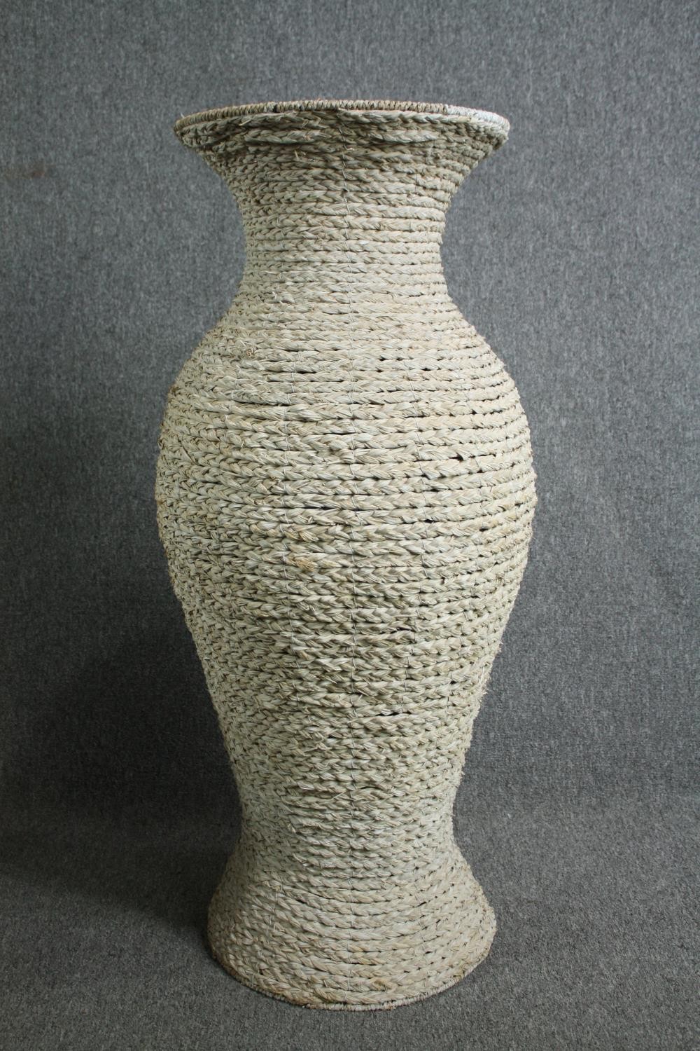 A pair of large modern rattan floor standing pots made from a metal frame with a weaved outer shell. - Image 2 of 6